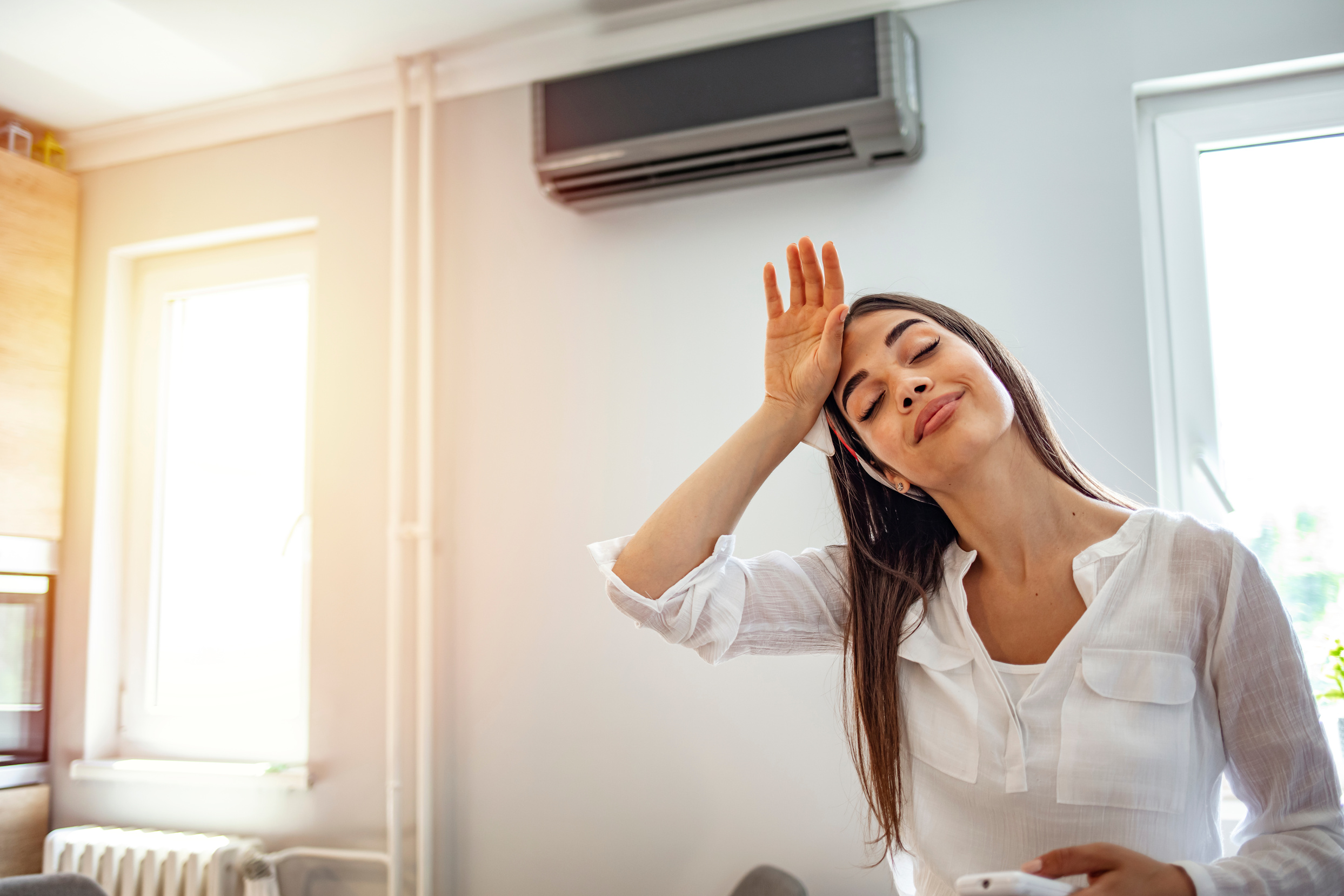 Woman and Air Conditioner At Home